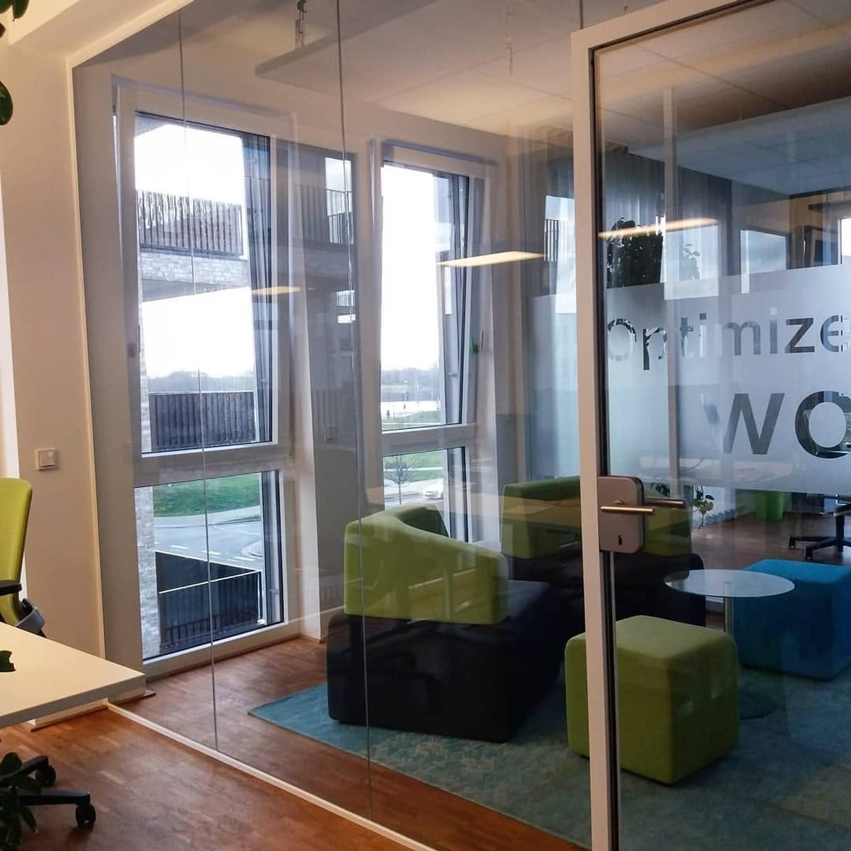 Ganzglas-Trennwände in einem Büro mit bedruckter Sichtschutzfolie und Blick ins Freie